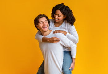 Loving Guy Carrying His Afro Girlfriend On Back, Having Fun Together