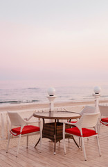  Terrace on the beach in winter. Red chairs