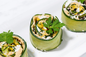 healthy vegetarian rolls with cucumber and hummus on a plate