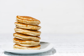 stack of delicious pancakes on white plate