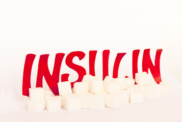 red cardboard insulin word surrounded by refined sugar cubes on white background, diabetes...