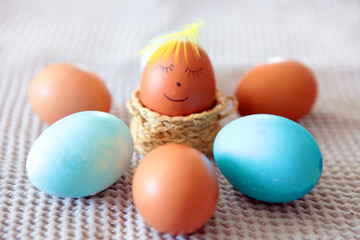 Colorful Easter eggs with smiling emoticon for handpaintings at home. brown eggs face arranged together on the paper background, Selective focus at the eeg. Many colorful organic chicen fresh eggs