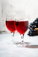 two glasses of red wine on a gray background, vertical