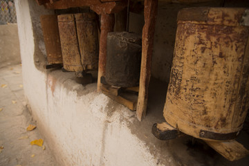 buddhist prayer wheels in himalayan temple