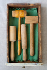 antique wooden pestles and mallets collection in a kitchen drawer