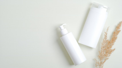 Natural cosmetics SPA branding mockup. Clear shampoo bottle and lotion packaging with dried flower. Beauty cosmetic product, skincare, body care concept