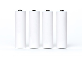 Four white batteries isolated on a white background.