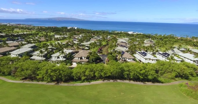 Wonderful aerial picture of blue ocean, luxurious resort built on a with relax zone surrounded by green gardens and palm trees in Hawaii