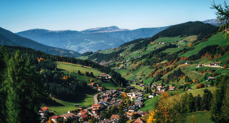 Aerial view of mountain alpine village and green meadows in Italian Dolomites Alps, Funes Valley,...