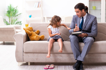 Child psychologist attending small girl