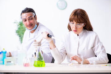 Two chemists working in the lab