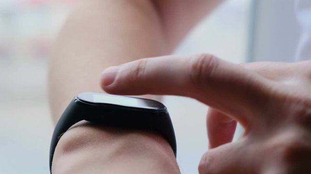 Man hands using smart fitness tracker watch, close