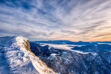 Fototapeta premium Winter mountain landscape at a sunny day with fog in the valleys. The Mala Fatra national park in Slovakia, Europe.
