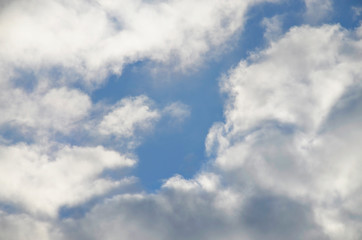 Fototapeta na wymiar In the blue sky, white and clouds. The sun illuminates the clouds.