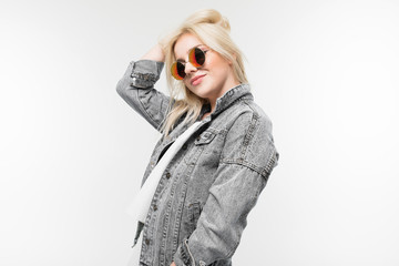 portrait of young girl in sunglasses isolated on background