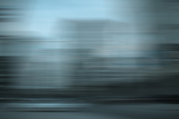 abstract blurred city background in dark blue and brown colors