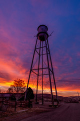Fototapeta na wymiar Colorful sunrise around a water tank in rural Idaho