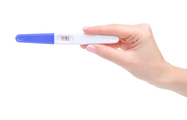 Positive pregnancy test in hand on white background isolation