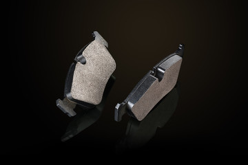 Car or automotive brake pads on black background