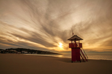 Watch tower on empty sand beach by the sea at sunset, Montenegro, Ulcinj,.Long beach