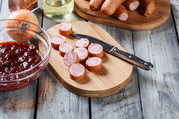 Ingredients ready for preparing German currywurst with curry sauce