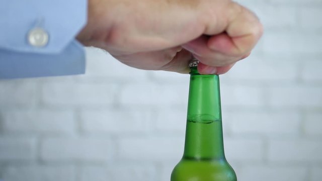 Thirsty Man Opens a Cold Bottle of Beer with Hand