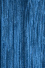 Blue wooden background. Wood texture in classic blue. Color of the 2020 year. Vertical photo.
