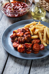 Traditional German currywurst - pieces of sausage with curry sau