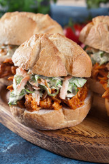 Pulled chicken sandwich with salad and bbq sauce