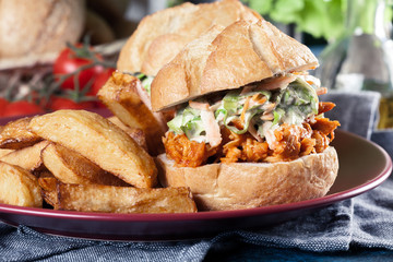 Pulled chicken sandwich with salad and bbq sauce