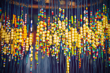 large number of bright colored baubles and occult charms made of wood for the body