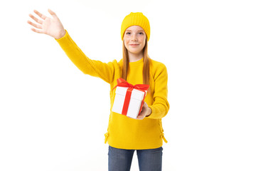Little caucasian girl holds a white box with gift and has a lot of emotions isolated on white background
