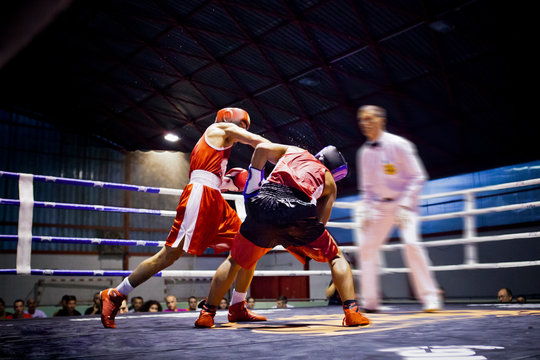 Two boxers fighting in a ring