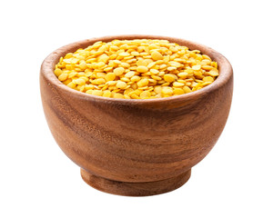 Yellow lentils in wooden bowl isolated on white background