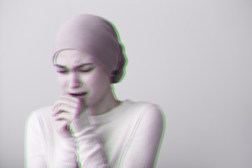Desperate woman after chemotherapy on light background