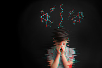 Sad little boy and drawing of separated parents on dark background. Concept of divorce