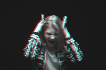 Screaming teenage girl on dark background