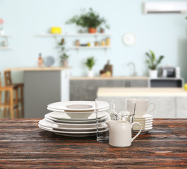 Set of clean tableware in modern kitchen