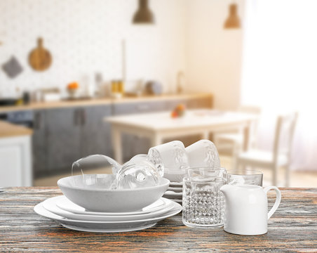 Set Of Clean Dishes On Table Against White Background