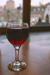 one glass of red wine on the table in a restaurant