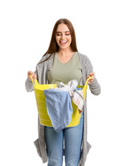 Beautiful young woman with laundry on white background