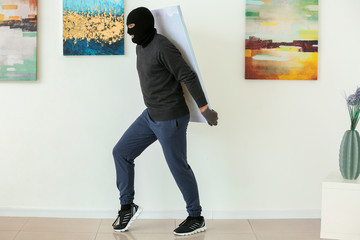 Fototapeta premium Thief stealing picture from art gallery