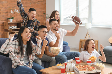 Group of fans watching rugby on TV