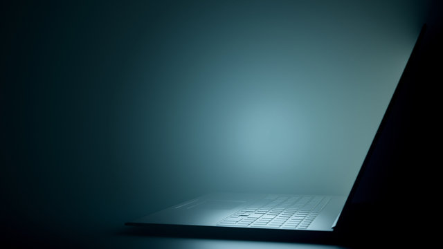 Digital Dark Workspace with a Modern Black Laptop. Realistic Laptop Side View with Copy Space. 3D Render.