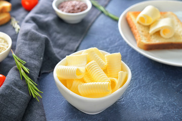 Bowl with fresh butter on table