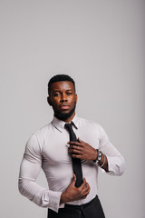 Happy confident young african american business male smiling with confidence, executive stylish company leader. Portrait of an businessman wearing suit and tie isolated on white background