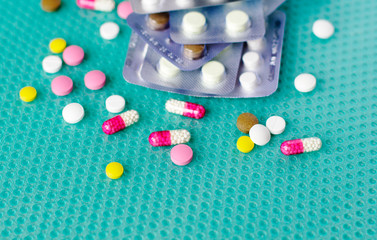 Pills and ampoules with medicine are scattered on the table