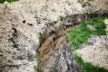 An earthen trench was dug for laying underground utilities.
