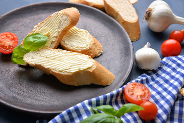 Plate with fresh bread and butter on table