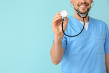 Male cardiologist on color background
